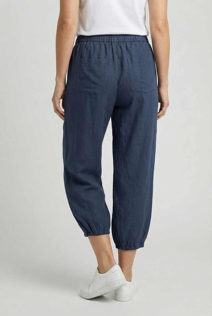 Side view of women's cotton trousers with a flattering high waist design.