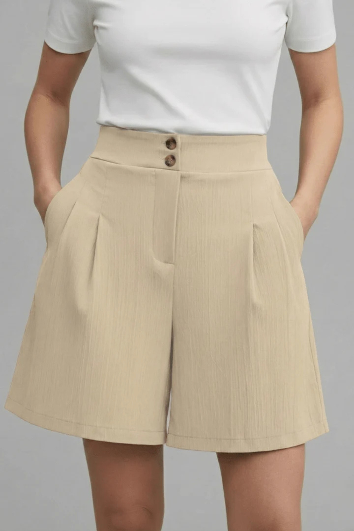 Button-front women's Bermuda shorts, high-waisted and pleated. Tailored for modern casual summer fashion.