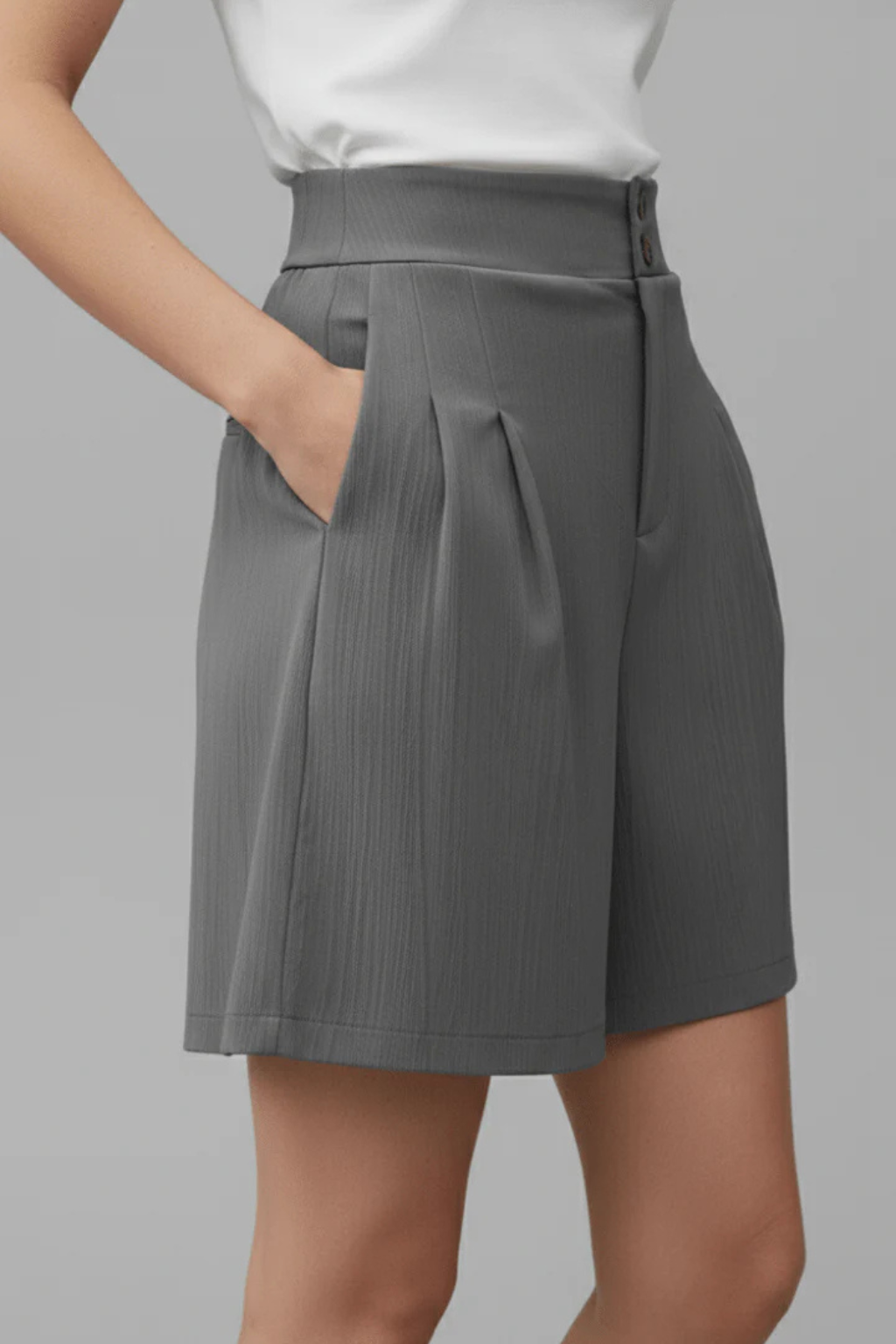 Tailored women's Bermuda shorts, high-waisted with smart pleats. Ideal for chic casual summer outfits.