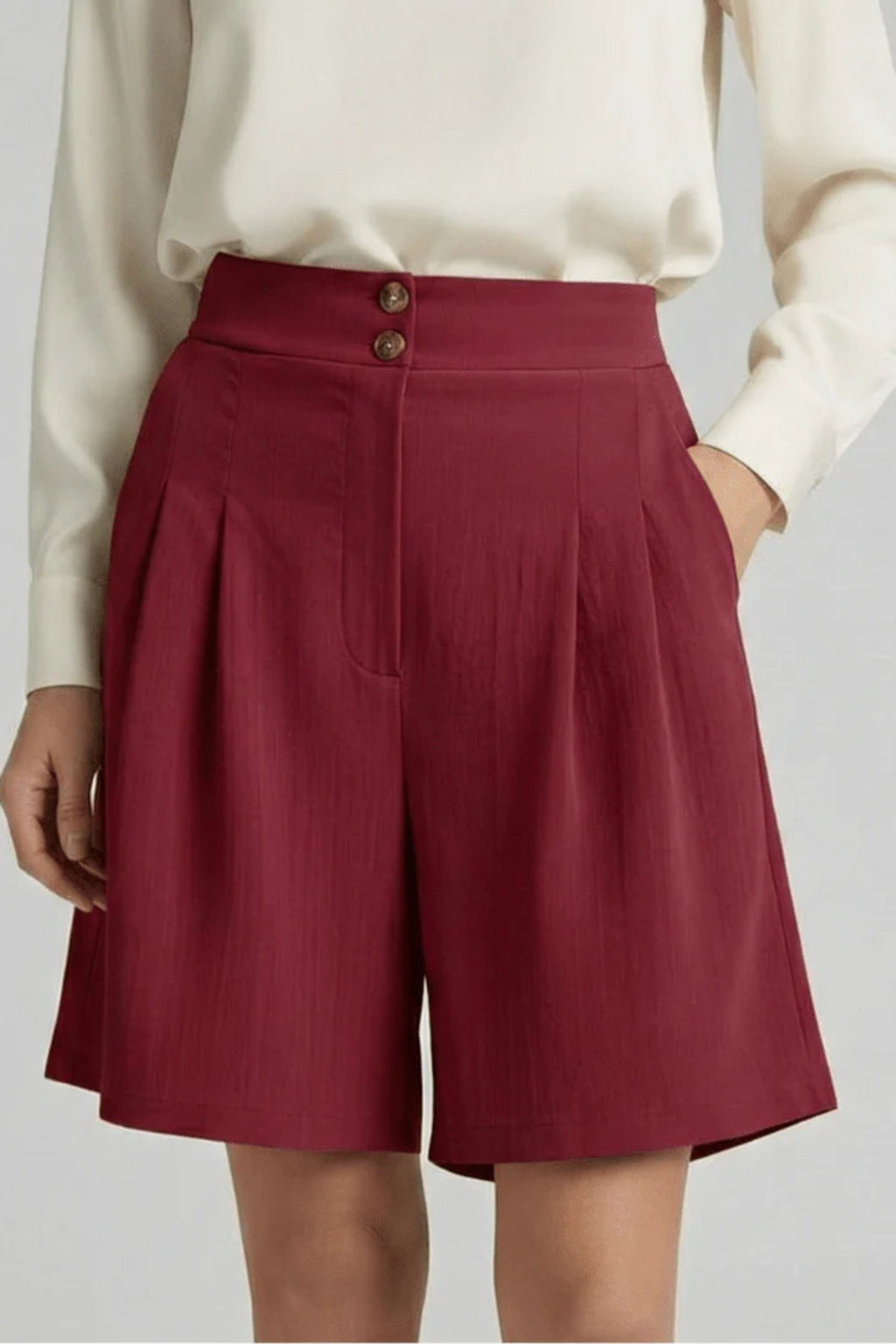 Modern women's high waist pleated tailored wide leg Bermuda shorts, perfect for casual chic outfits.