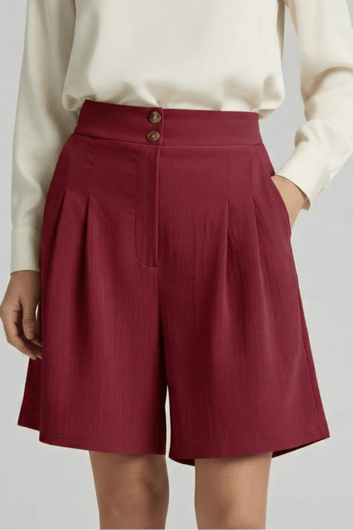 Modern women's high waist pleated tailored wide leg Bermuda shorts, perfect for casual chic outfits.