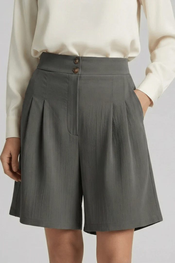 Elegant women's pleated high waist tailored Bermuda shorts, a stylish addition to your summer wardrobe.