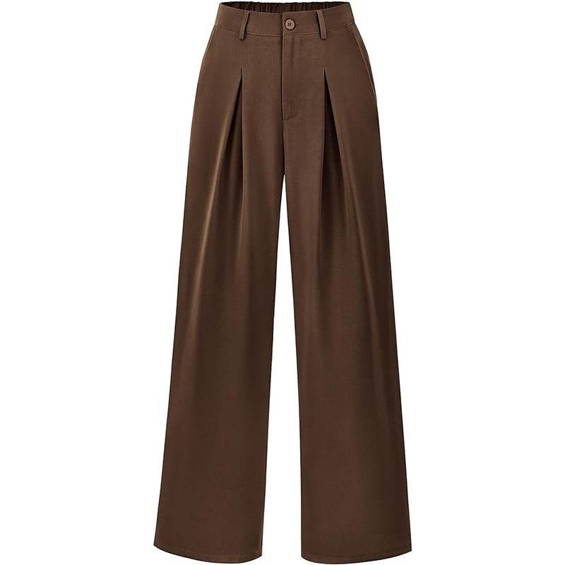 Model in flowing wide leg pleated trousers, high waist design. Stylish and comfortable women's pants.