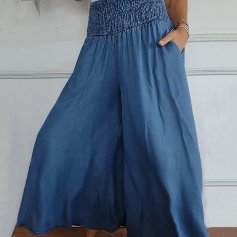 Flowing wide-leg denim trousers for women, featuring a high-waist & smocked waistband for comfort.