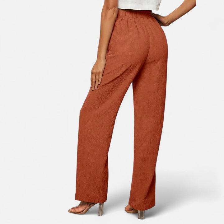 Model wearing elegant navy straight-leg trousers, showcasing their versatility for any occasion.