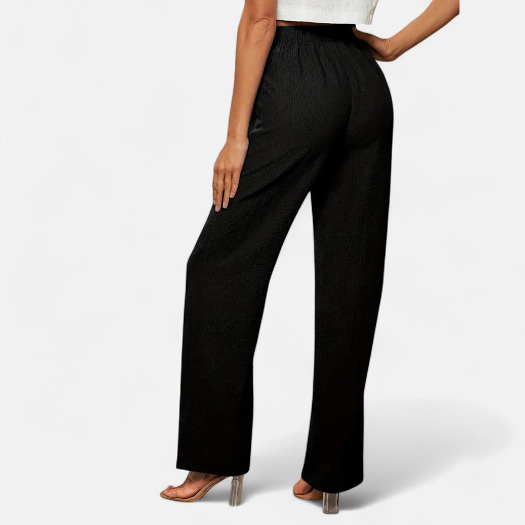 A pair of sophisticated women's tailored trousers in black, emphasizing the flattering straight-leg silhouette.