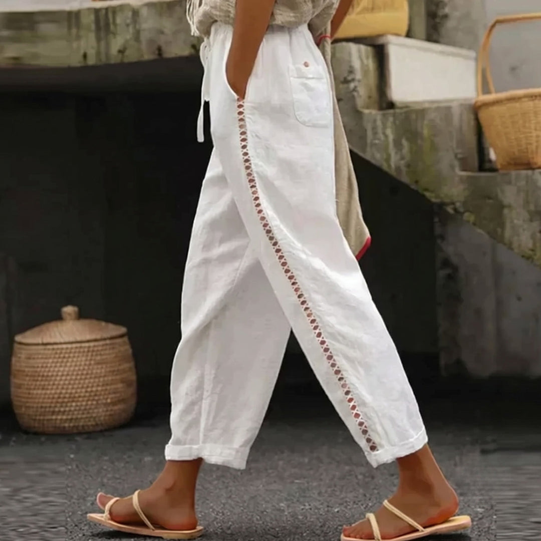 Women's high-waist striped trousers. Elegant and versatile for casual or office wear. Chic summer fashion bottoms.