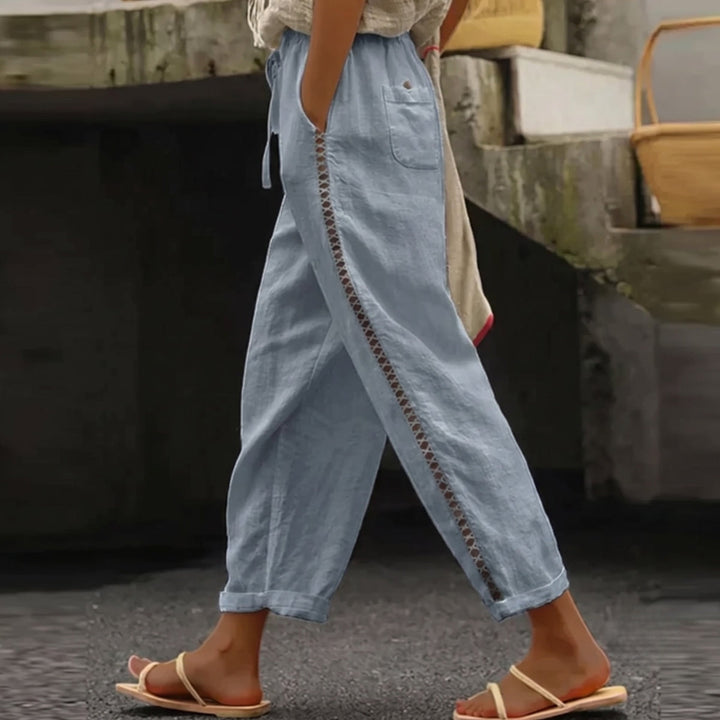 Fashionable women's high-waist striped pants. Elegant tapered leg design for chic casual or professional attire.