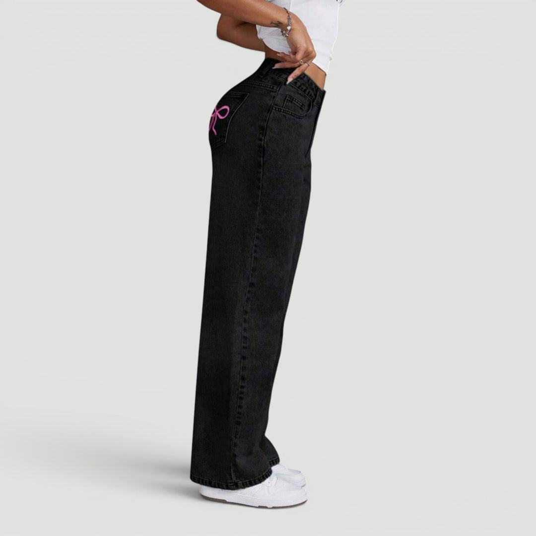 Women's high waist wide leg denim trousers with chic embroidered details.