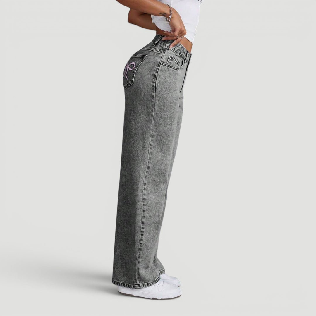 Elegant high waist wide leg denim trousers for women, with subtle embroidery.