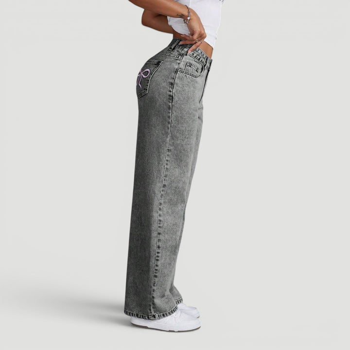 Elegant high waist wide leg denim trousers for women, with subtle embroidery.