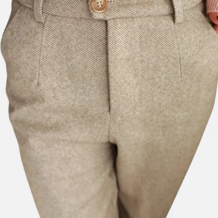 Close-up of the premium wool blend fabric on women's elegant high-waist pencil trousers.