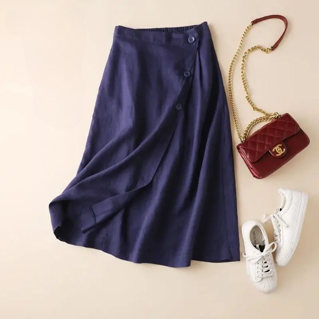 Women's high-waisted A-line midi skirt with stylish side buttons, perfect for elegant smart casual outfits.