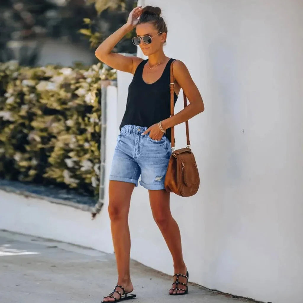 Trendy women's distressed denim shorts, high-waisted with a chic rolled hem. Ideal for everyday casual summer fashion.