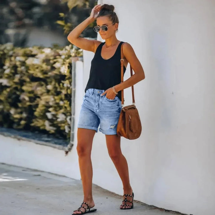 Trendy women's distressed denim shorts, high-waisted with a chic rolled hem. Ideal for everyday casual summer fashion.