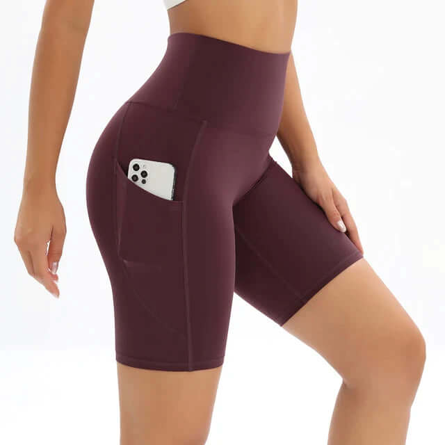 Women's high-waisted fitness shorts in black with a convenient side pocket for activewear & workouts.