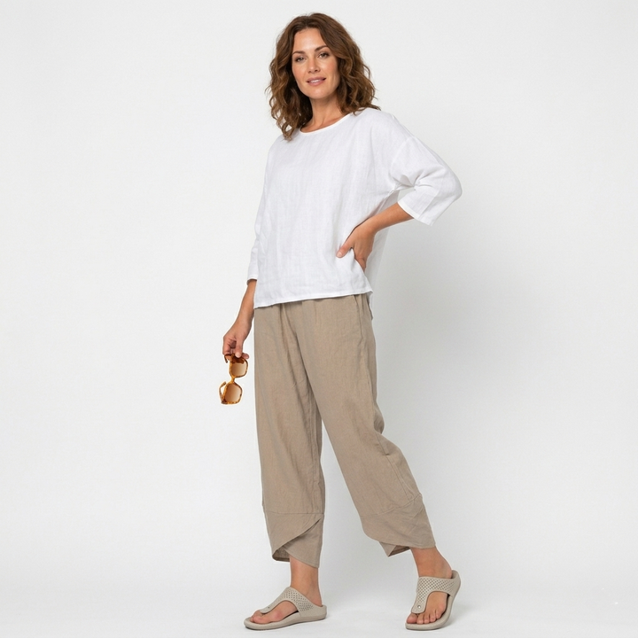 Close-up of the elegant tulip hem on women's high-waisted summer trousers for a chic look.