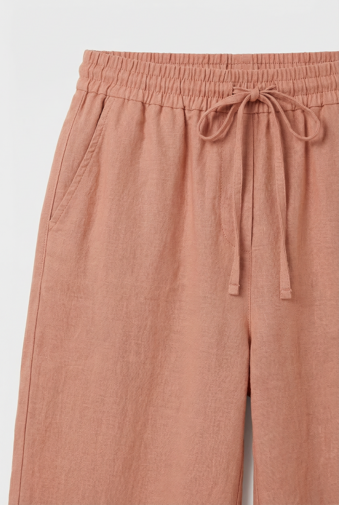 Model wearing fashionable high-waisted wide-leg pants, a versatile summer staple.