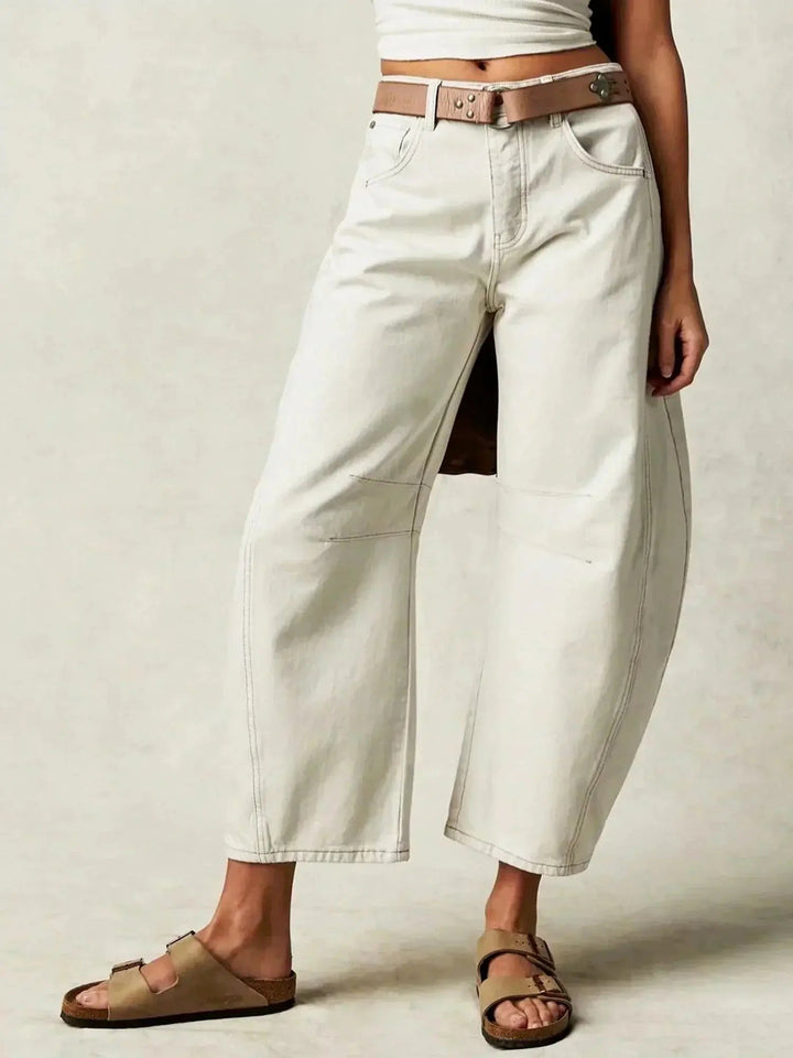 Fashionable women's high-waisted wide-leg jeans in a striking animal print, perfect for trendy outfits.