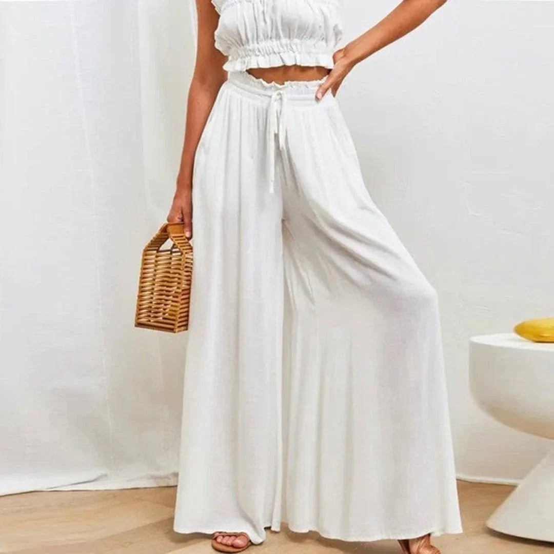 Women's high-waisted wide leg pants with smocked drawstring waist, comfortable & flowy fit for casual wear.