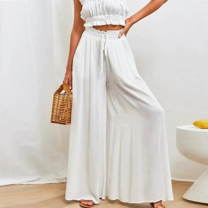 Women's high-waisted wide leg pants with smocked drawstring waist, comfortable & flowy fit for casual wear.