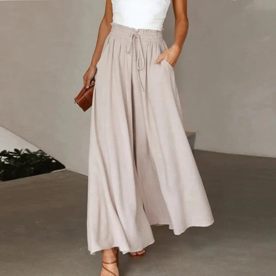 Trendy high-waisted wide leg pants for women with a smocked drawstring waist, offering a stylish, flowy silhouette.