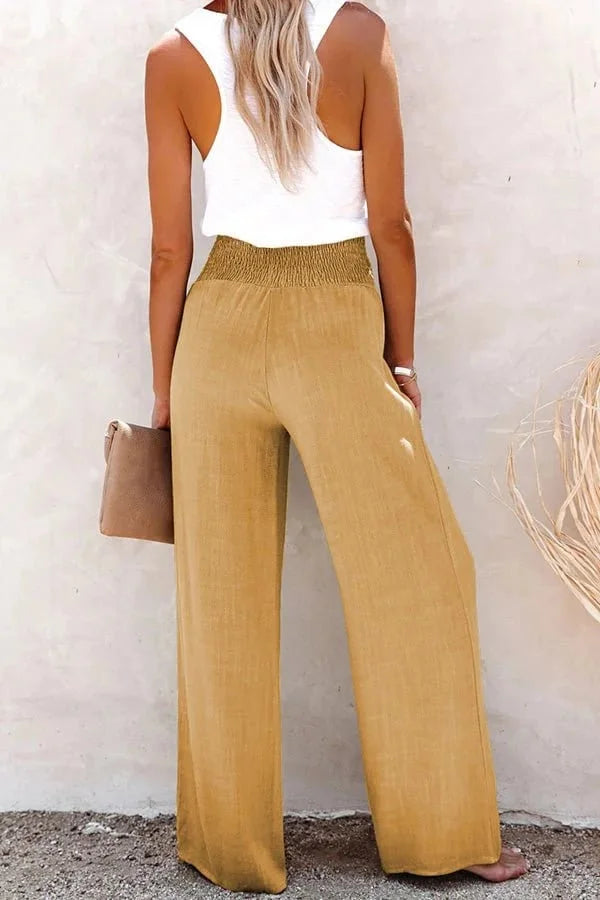 Trendy women's high-waisted wide-leg trousers, featuring a unique smocked button front for various occasions.