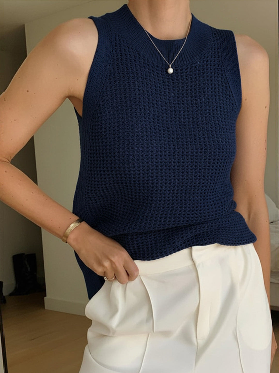 Versatile women's sleeveless top, boasting a beautiful hollow design for comfortable warm weather outfitting.