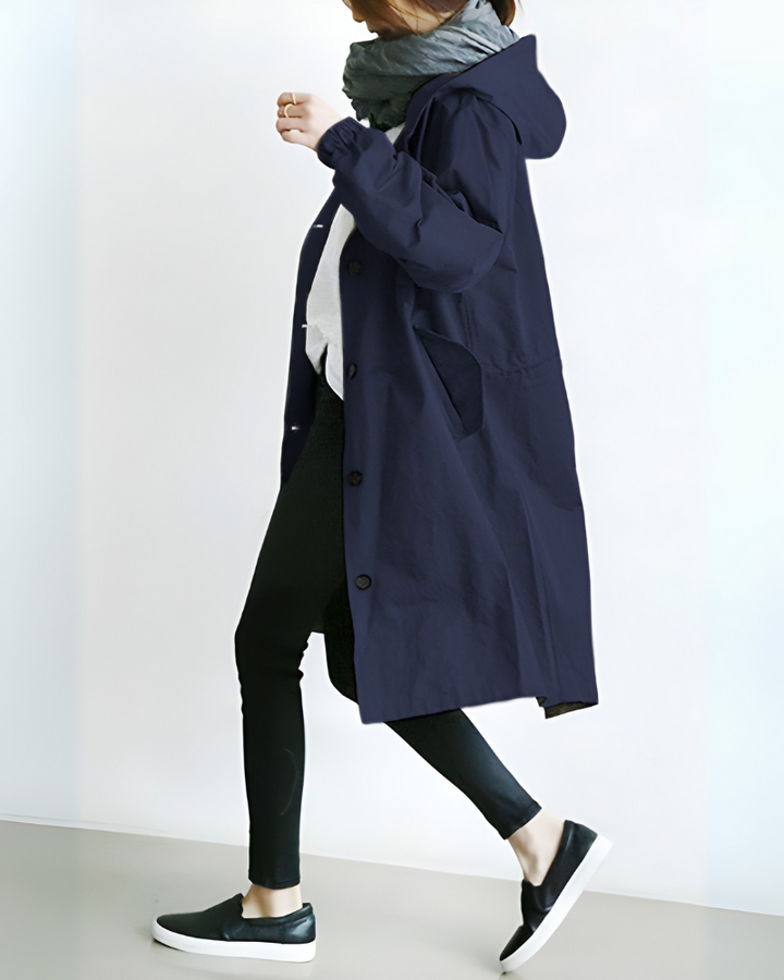 Back view of a long, elegant women's trench coat with a hood