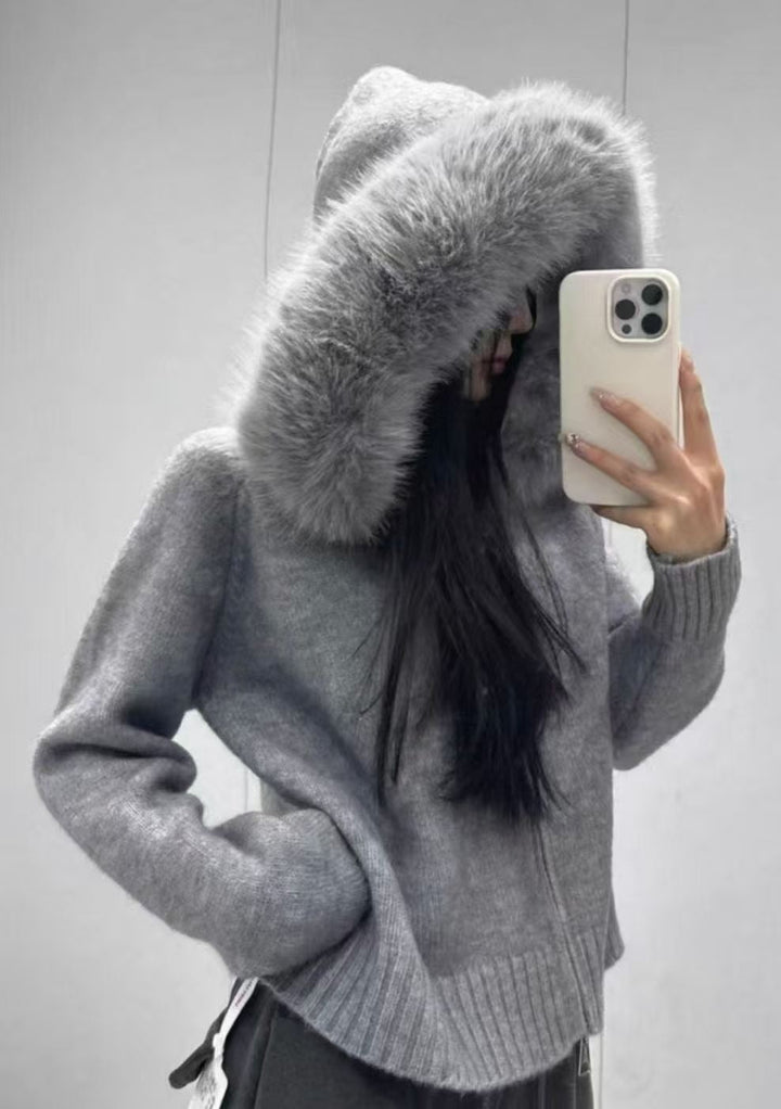 Stylish hooded knit jacket for women, offering cozy wear and trendy winter fashion with fur trim.