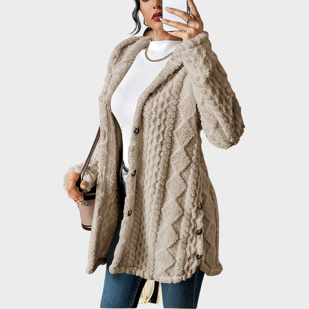 Cozy women's longline hooded cardigan. Soft textured knit, button front, ideal for comfortable casual style.