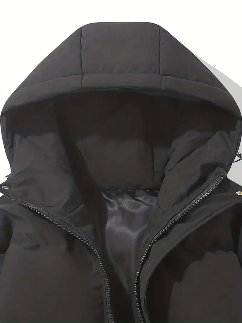Woman wearing a stylish hooded puffer jacket, perfect for winter adventures.