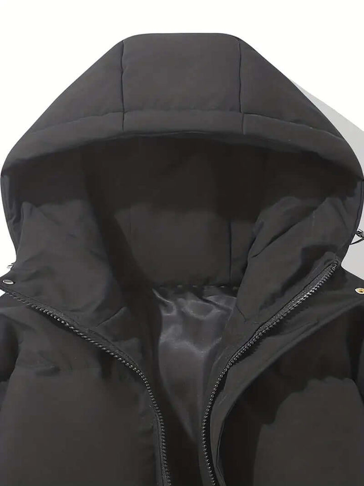 Woman wearing a stylish hooded puffer jacket, perfect for winter adventures.