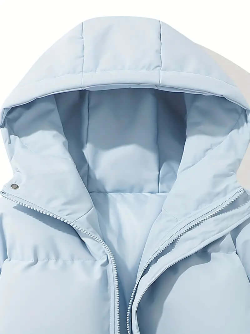 Side profile: Women's cold weather hooded puffer jacket, sleek design & warmth.