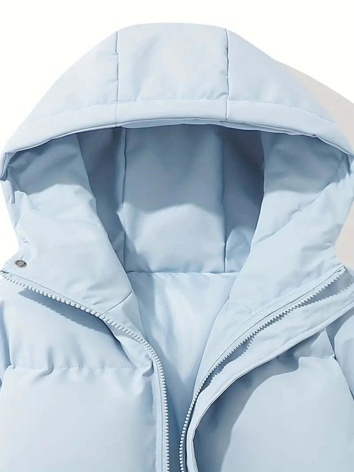 Side profile: Women's cold weather hooded puffer jacket, sleek design & warmth.