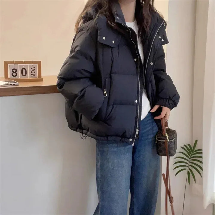 Women's hooded puffer jacket with high neck, perfect for winter warmth & style.