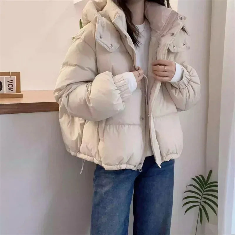 Practical women's hooded puffer jacket with high neck, offering superior warmth & cold protection.
