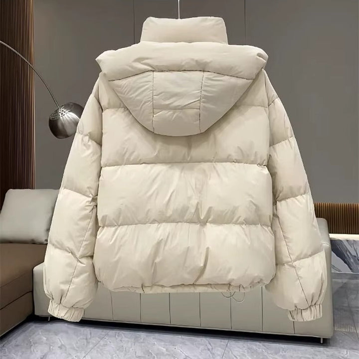 Weather-resistant women's hooded puffer coat, high neck shields from wind & cold in winter.