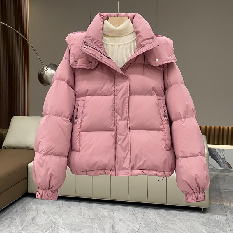 Contemporary women's high-neck puffer coat, hooded for ultimate warmth & stylish winter outerwear.