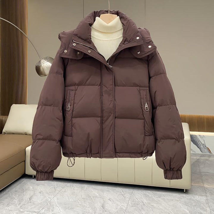 Durable women's hooded puffer coat with a protective high neck, perfect for severe winter.