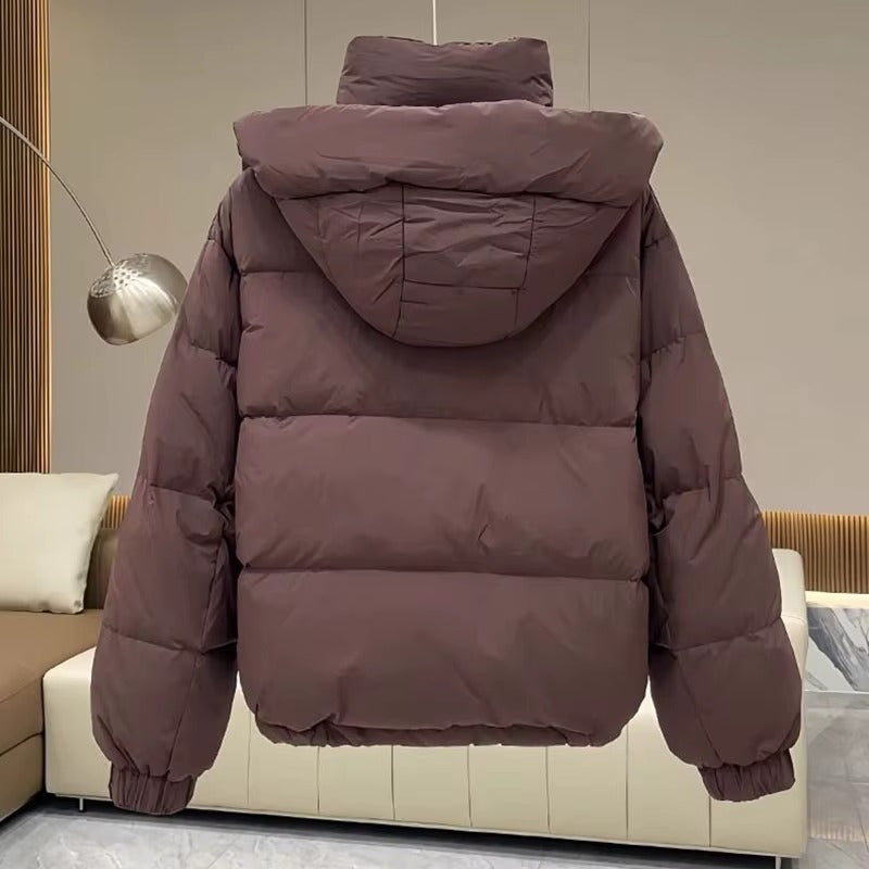 Outdoor-ready women's hooded puffer jacket, high neck provides extra warmth for winter adventures.