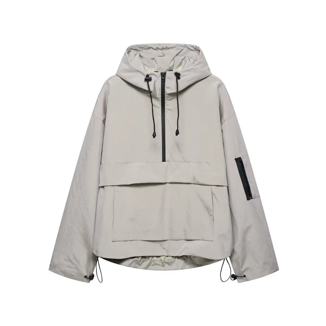 Close-up of a women's half-zip quilted anorak. Oversized, hooded windproof pullover jacket, perfect for spring layering.