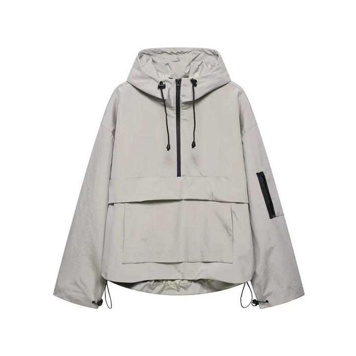 Close-up of a women's half-zip quilted anorak. Oversized, hooded windproof pullover jacket, perfect for spring layering.