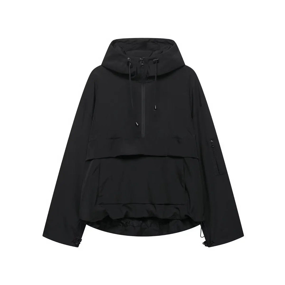 Woman wearing a casual hooded quilted anorak pullover jacket. Windproof & weather-resistant outerwear for outdoor activities.