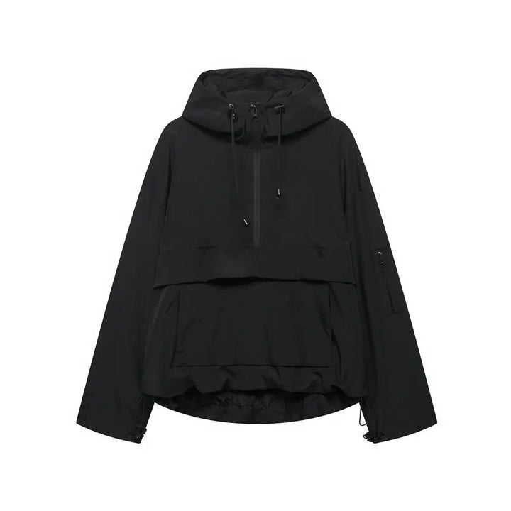 Woman wearing a casual hooded quilted anorak pullover jacket. Windproof & weather-resistant outerwear for outdoor activities.