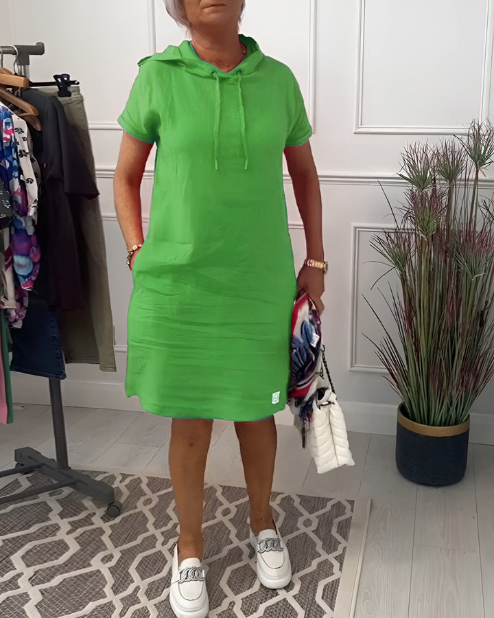 Back view: women's hooded short sleeve dress, showcasing hood detail and casual fit.