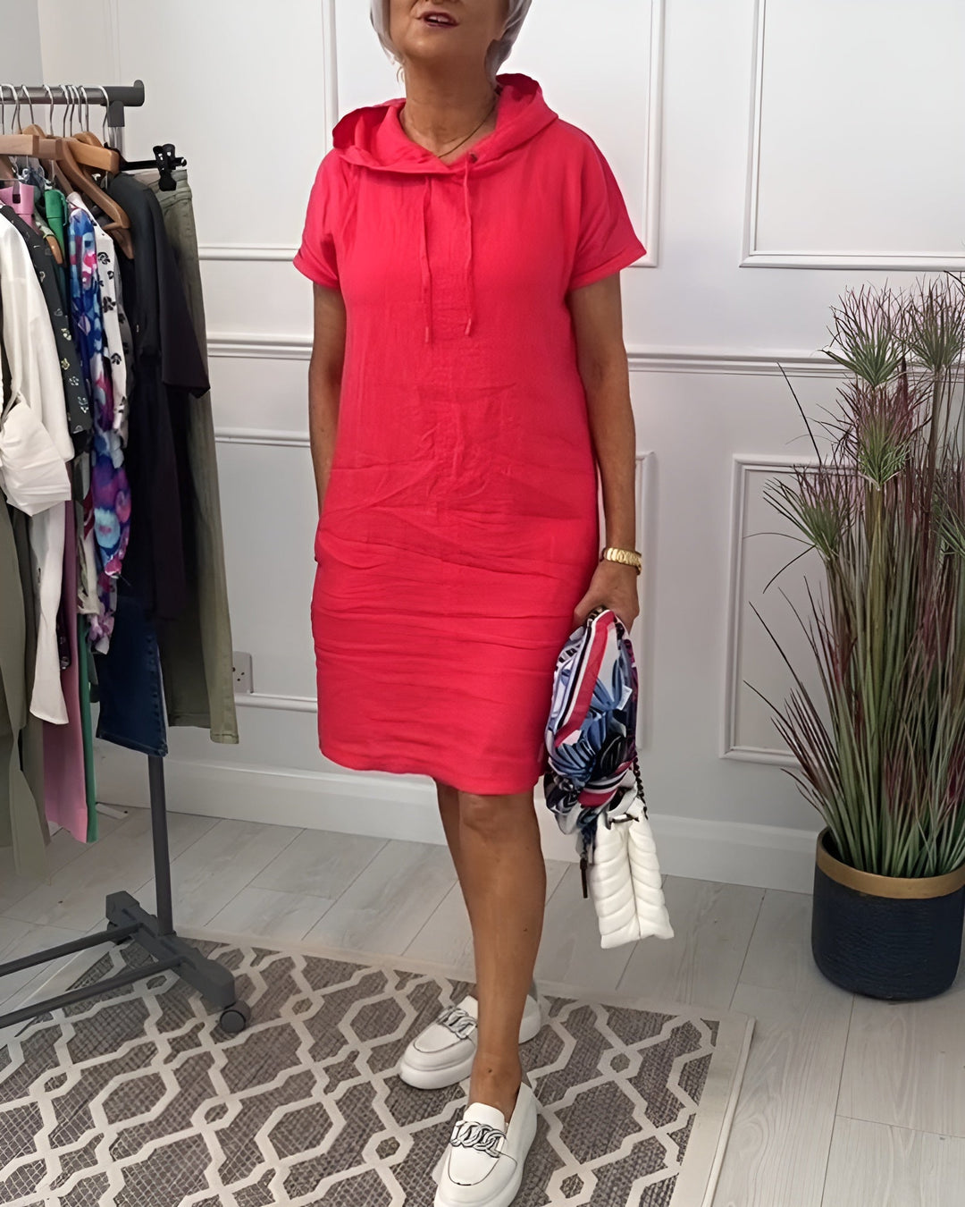 Woman wearing a casual hooded short sleeve dress with pocket, perfect for everyday comfort.