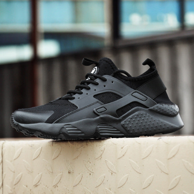 Women's Huarache sneakers in white, offering breathable comfort for everyday wear.