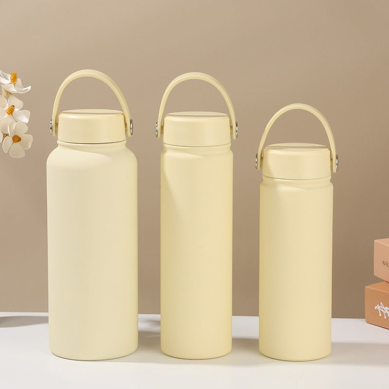 Convenient women's insulated water bottle with ergonomic handle for easy carrying, hot/cold beverages.