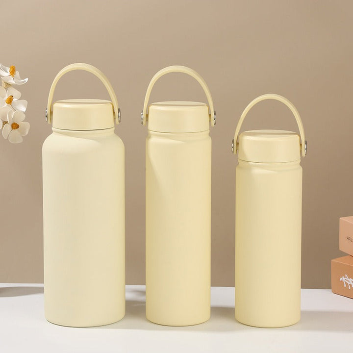 Convenient women's insulated water bottle with ergonomic handle for easy carrying, hot/cold beverages.